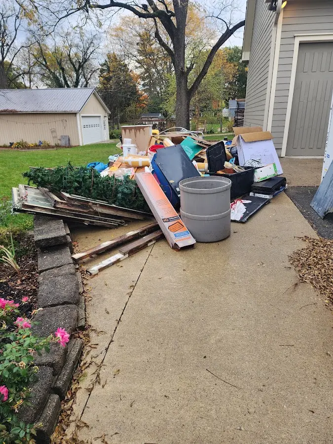 Dumpster being loaded with debris for Roofing Dumpster Rental in North Royalton
